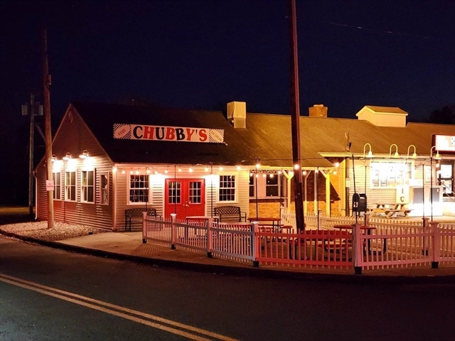 Chubby's restaurant lit up at night with outdoor seating